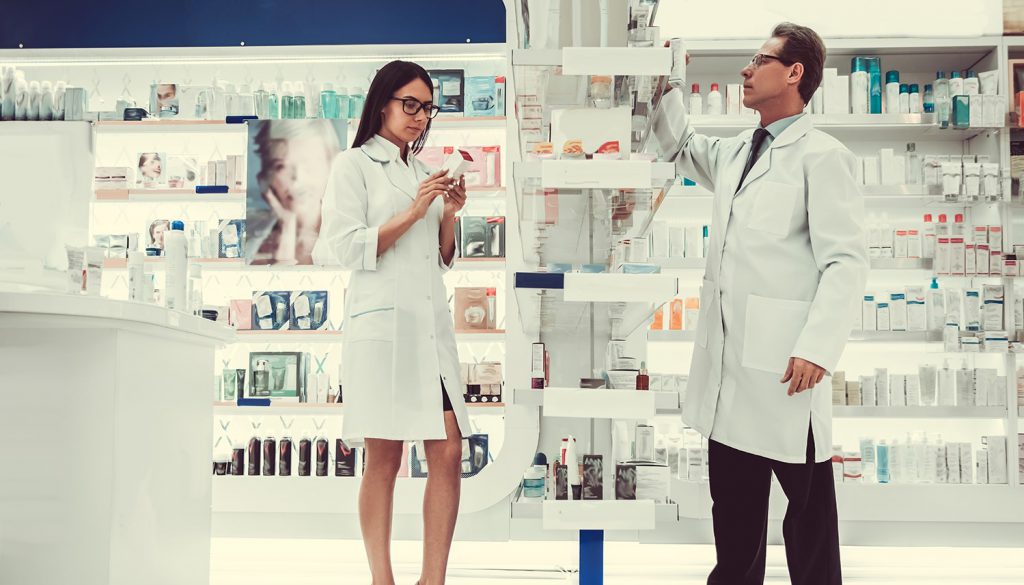 Full length portrait of beautiful pharmacists searching for medications while working in pharmacy