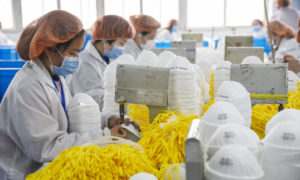 This photo taken on February 28, 2020 shows workers producing face masks at a factory in Handan in China's northern Hebei province. - The number of deaths globally in the new coronavirus outbreak passed 3,000 on March 2, as China reported more 42 deaths. (Photo by STR / AFP) / China OUT (Photo by STR/AFP via Getty Images)